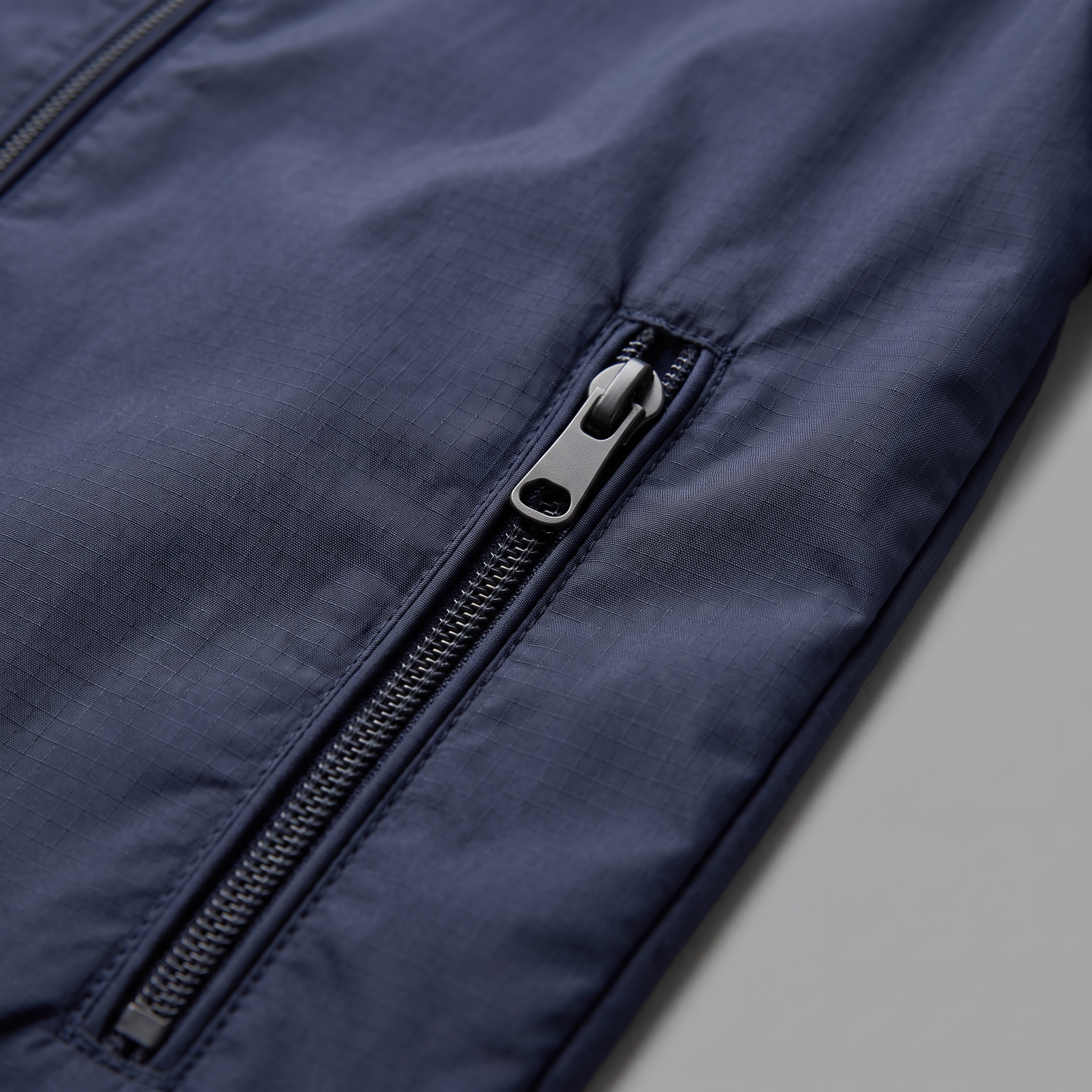 Windbreaker zipped pocket and ripstop detail