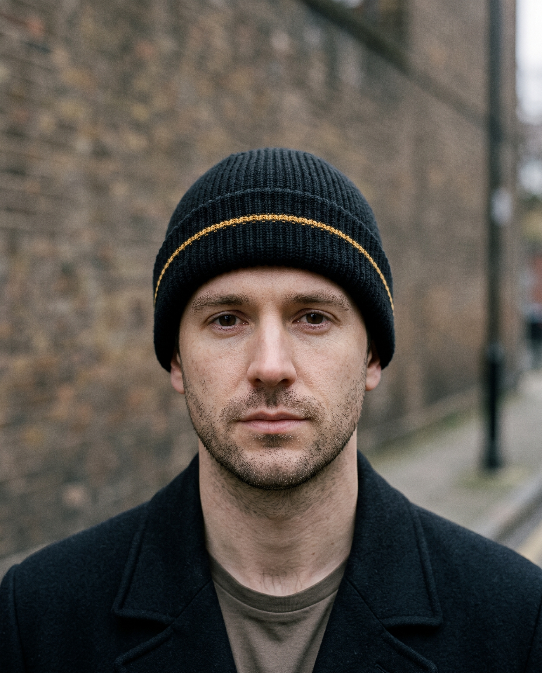 Man wearing black ribbed beanie, head and shoulders