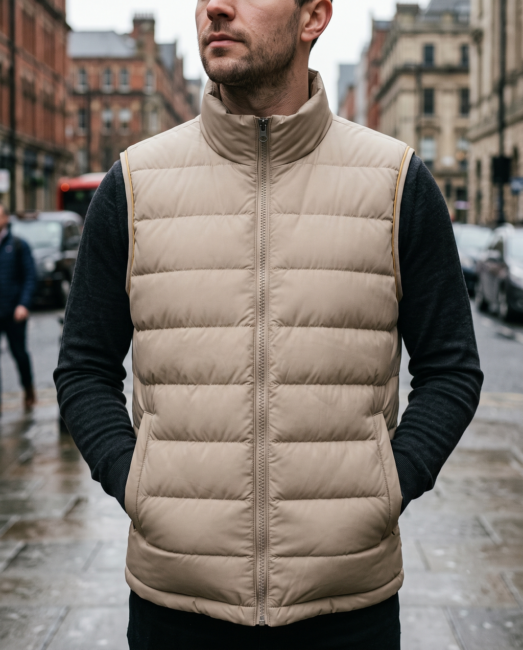 Close crop of sand beige gilet worn over a dark top